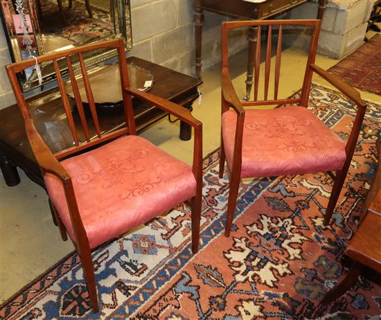 A pair of Gordon Russell teak elbow chairs